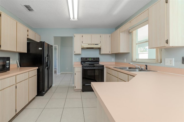 kitchen with light countertops, black appliances, a sink, and under cabinet range hood