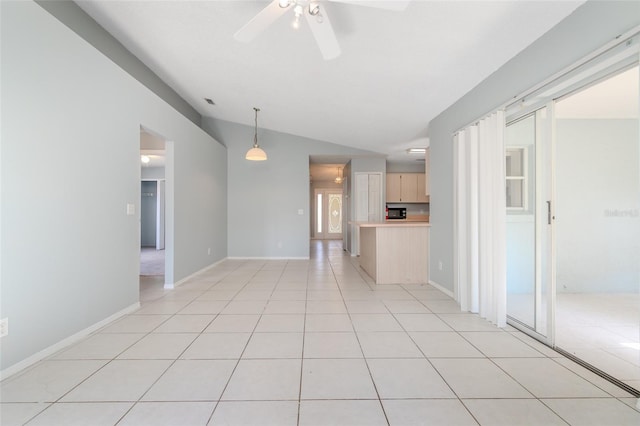 unfurnished room with light tile patterned floors, ceiling fan, baseboards, and vaulted ceiling