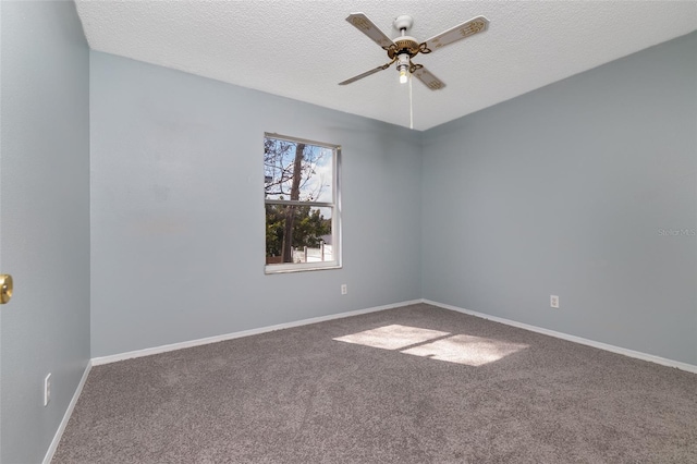 unfurnished room with a ceiling fan, carpet flooring, a textured ceiling, and baseboards