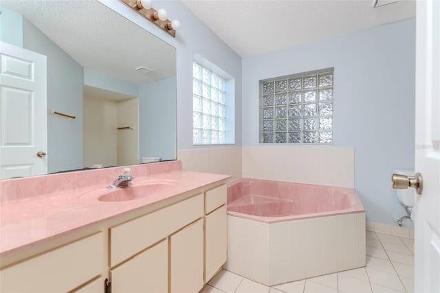 full bathroom featuring visible vents, tile patterned floors, a garden tub, a textured ceiling, and vanity