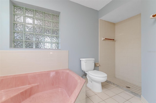 full bathroom featuring tiled shower, a garden tub, toilet, and tile patterned floors