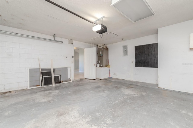 garage with concrete block wall, electric panel, and a garage door opener