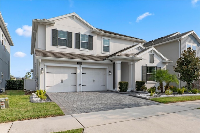 view of front of house featuring a garage and a front yard