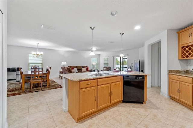 kitchen with sink, black dishwasher, an island with sink, pendant lighting, and a healthy amount of sunlight