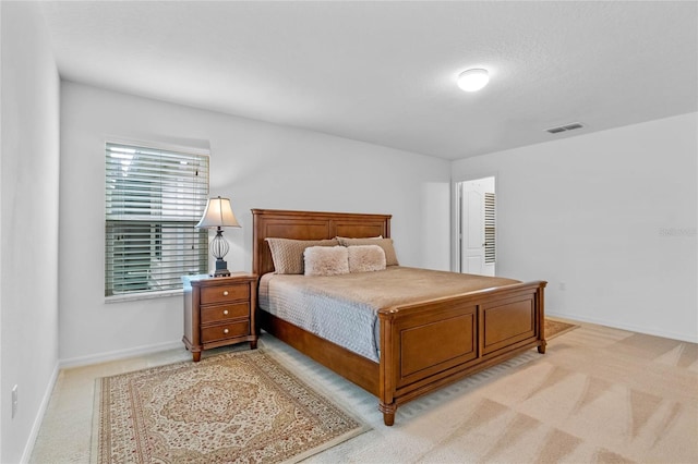 bedroom with light colored carpet