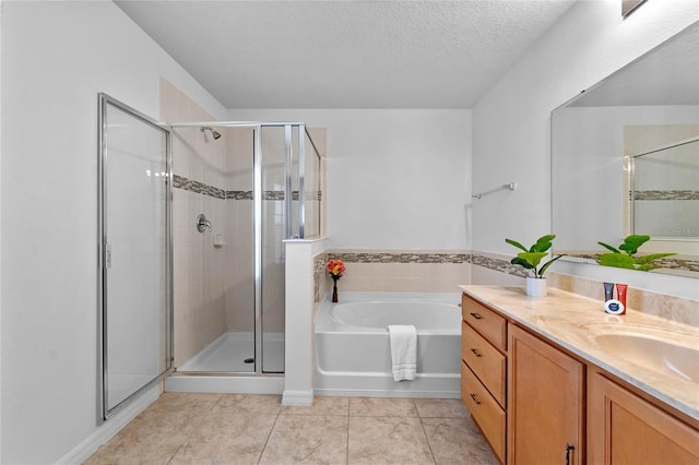 bathroom with tile patterned floors, shower with separate bathtub, vanity, and a textured ceiling