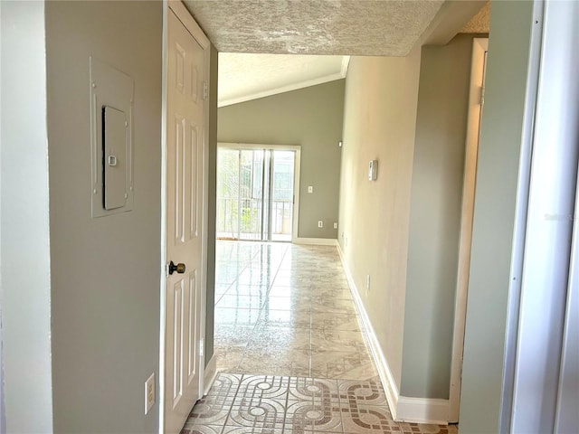 hallway featuring lofted ceiling, crown molding, and a textured ceiling