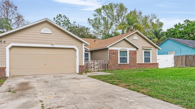 single story home with brick siding, an attached garage, a front yard, fence, and driveway