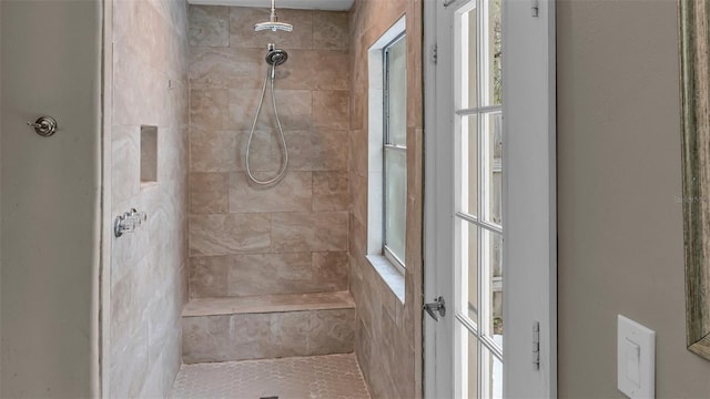 bathroom with a tile shower