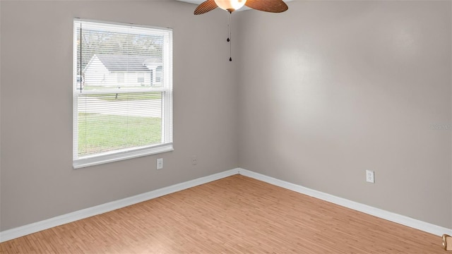 unfurnished room with light wood finished floors, ceiling fan, and baseboards