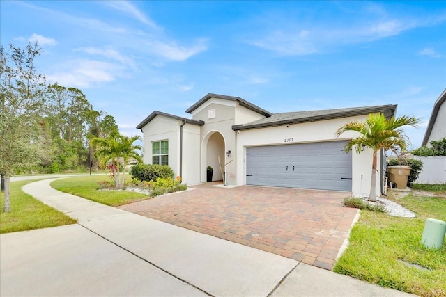 view of front of home with a garage and a front lawn