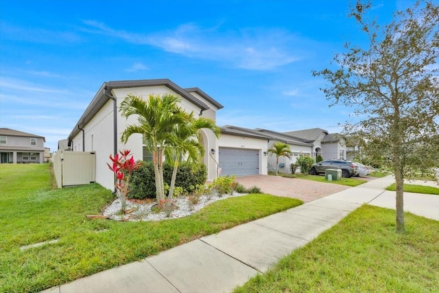 view of front of property featuring a garage and a front lawn