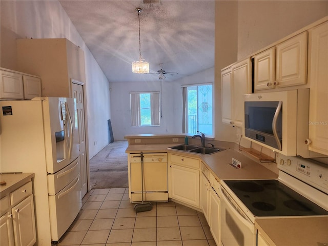 kitchen with white appliances, light tile patterned flooring, pendant lighting, sink, and kitchen peninsula