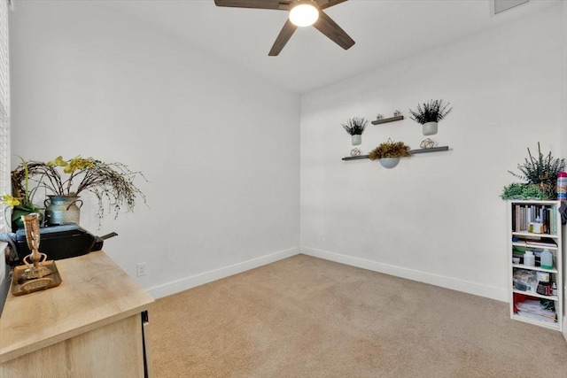 office featuring light carpet and ceiling fan