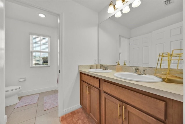 bathroom featuring a notable chandelier, toilet, tile patterned flooring, and vanity