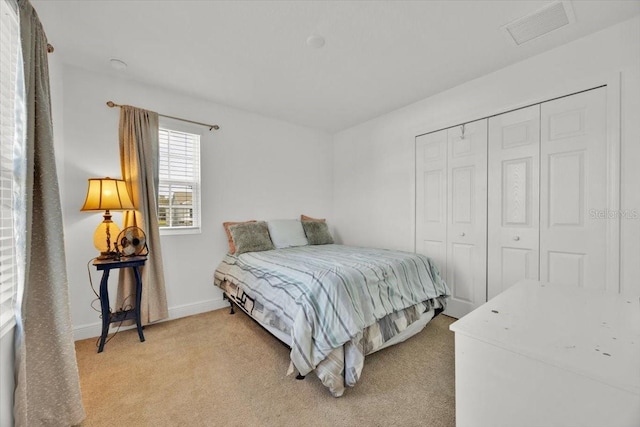 bedroom with a closet and light colored carpet