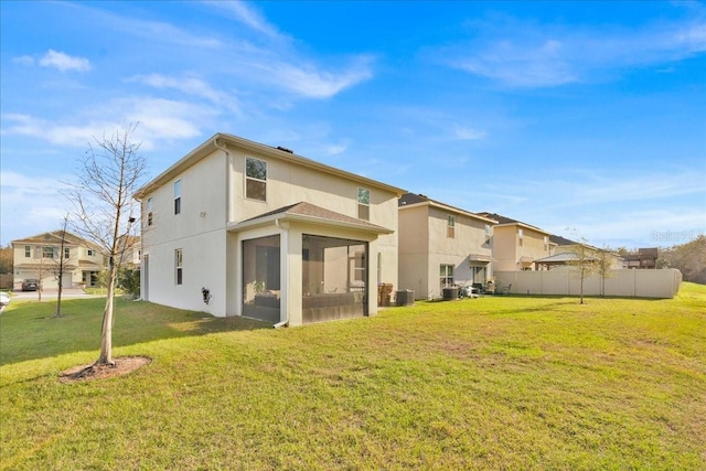 back of property with cooling unit, a yard, and a sunroom