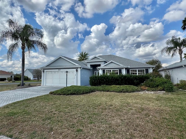 single story home featuring a garage and a front lawn