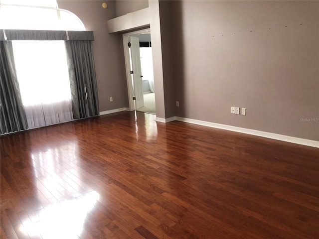 spare room with dark wood-type flooring