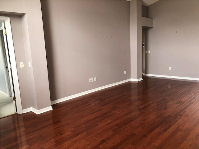 unfurnished room with dark hardwood / wood-style floors