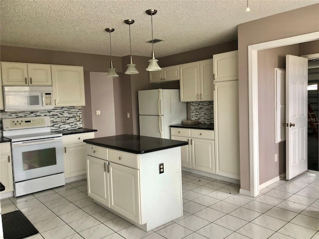 kitchen featuring pendant lighting, white appliances, and light tile patterned floors