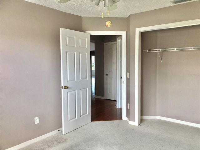 unfurnished bedroom featuring a textured ceiling and a closet