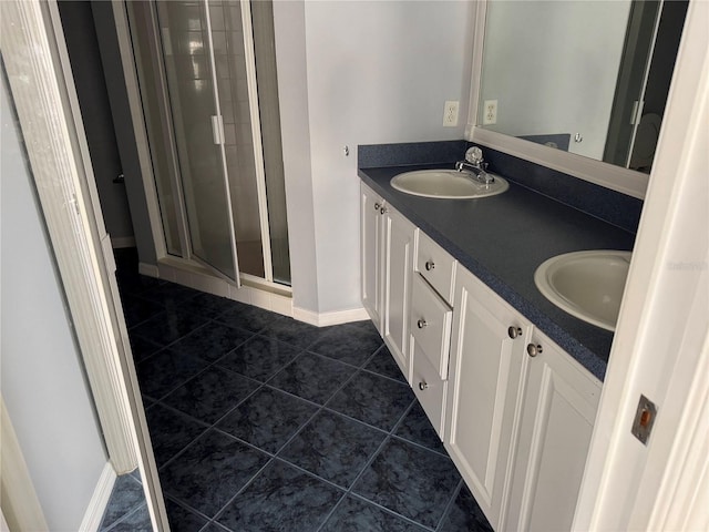 bathroom with tile patterned flooring, vanity, and a shower with shower door