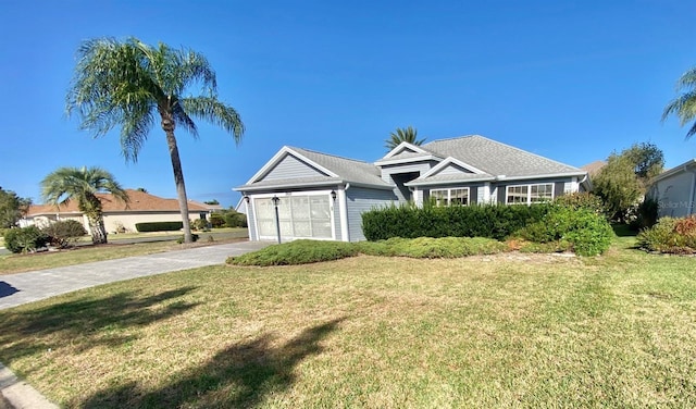 ranch-style house featuring a garage and a front yard