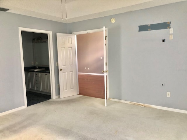 2628 Caribe Dr, The Villages, FL 32162 - unfurnished bedroom featuring carpet flooring and ensuite bath