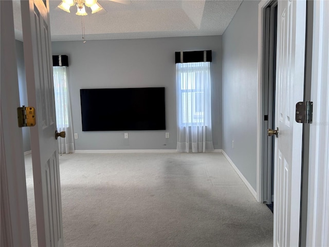 2628 Caribe Dr, The Villages, FL 32162 - unfurnished room with carpet flooring, a ceiling fan, and a textured ceiling