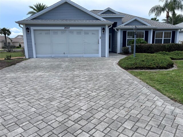 2628 Caribe Dr, The Villages, FL 32162 - ranch-style house featuring driveway and an attached garage