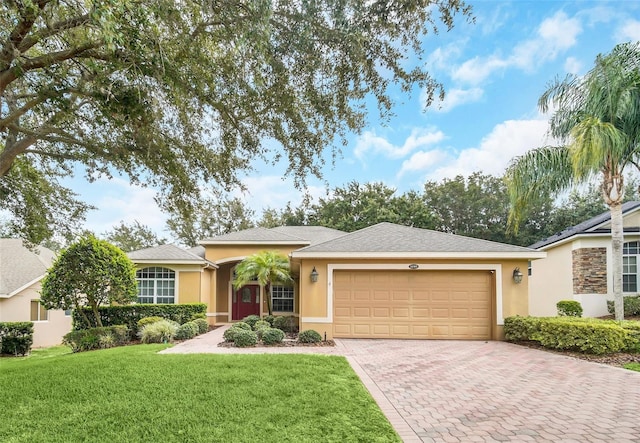 single story home featuring a garage and a front lawn