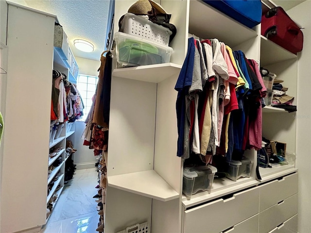 spacious closet with marble finish floor