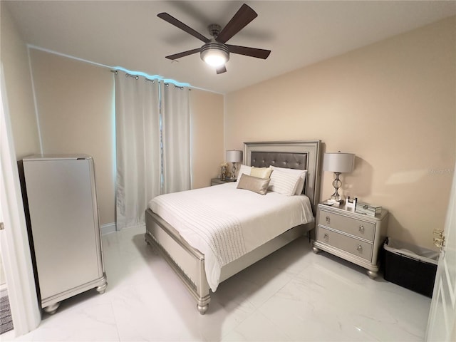 bedroom featuring marble finish floor and a ceiling fan