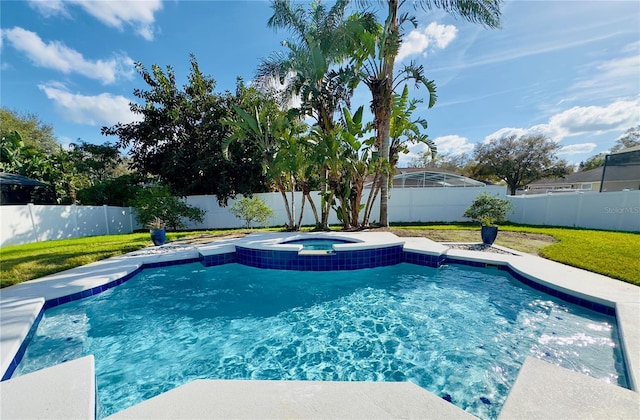 view of swimming pool featuring a fenced backyard, a pool with connected hot tub, and a yard