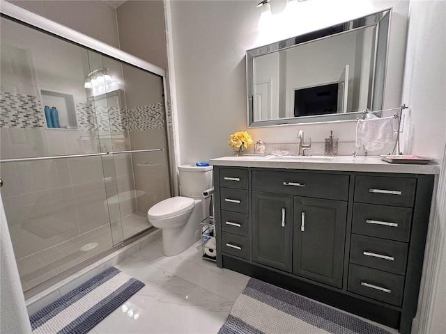 bathroom featuring toilet, marble finish floor, a shower stall, and vanity