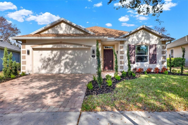 view of front of home with a garage and a front lawn