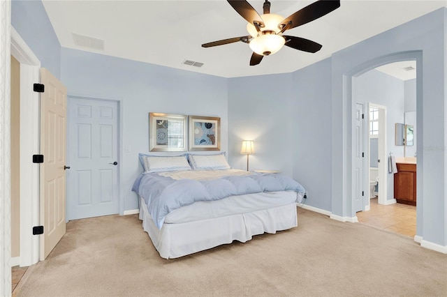 carpeted bedroom featuring ceiling fan and connected bathroom