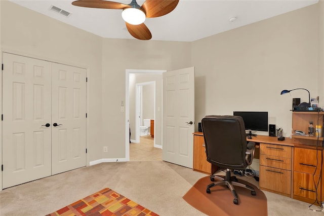 home office featuring light colored carpet and ceiling fan