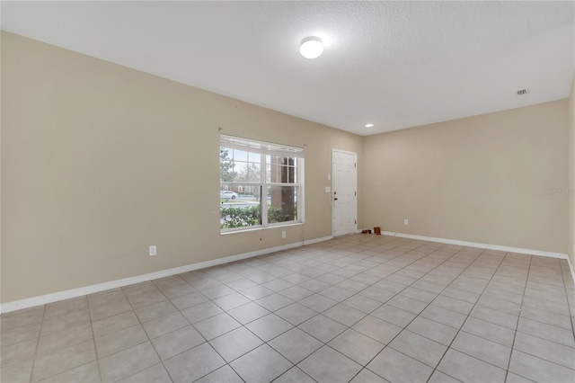 spare room featuring visible vents and baseboards