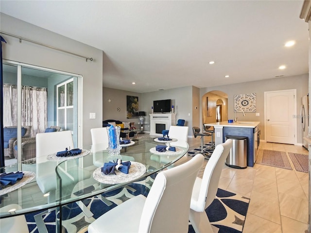 dining room featuring light tile patterned flooring and sink