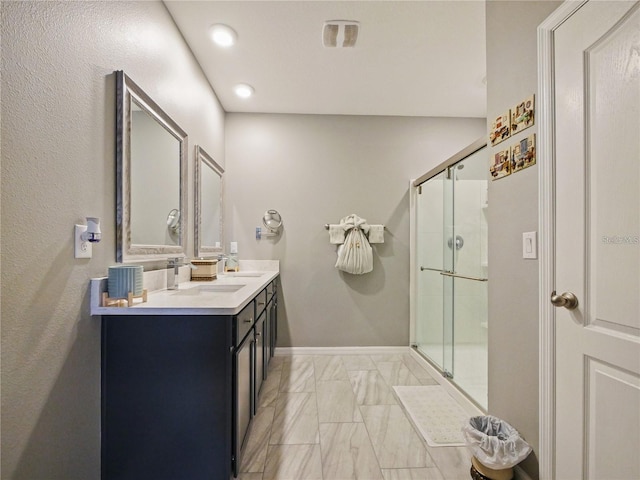 bathroom featuring vanity and a shower with door