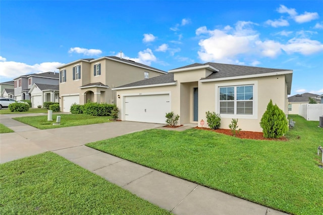 view of front of home with a garage, driveway, a front yard, and stucco siding