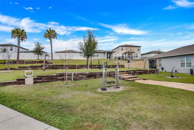 view of play area featuring fence and a lawn