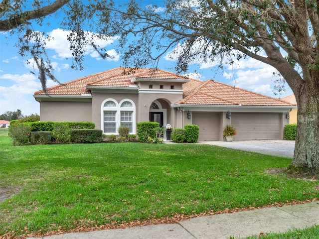 mediterranean / spanish-style house featuring a garage, a front yard, and a tile roof