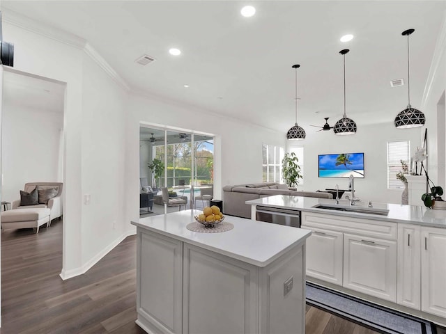 kitchen with a center island, light countertops, open floor plan, white cabinets, and dishwasher