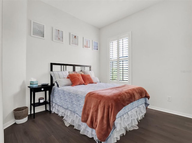 bedroom with dark wood-style floors and baseboards