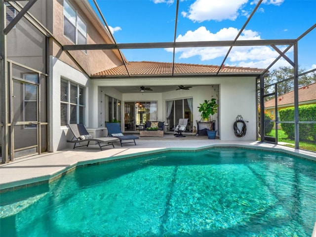 pool with ceiling fan, a patio area, and a lanai