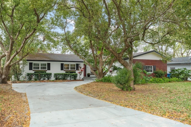 ranch-style home with brick siding and concrete driveway