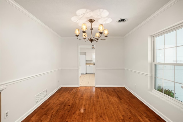 unfurnished dining area with a notable chandelier, baseboards, visible vents, and ornamental molding